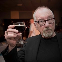 The late  David Hughes celebrating with a glass of red wine