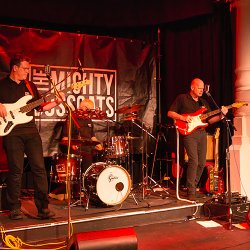 Picture of singers The Mighty Bosscats on stage with their equipment