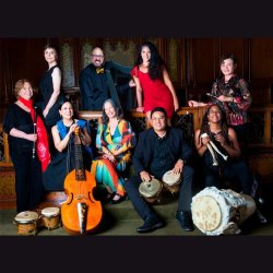 Nine musicians posed with their instruments in a dark interior.