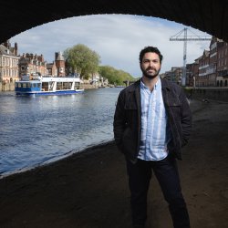 Portrait of a bearded man, under a bridge, on a pathway long the river Ouse.