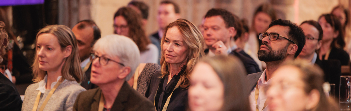 People sat listening to a session at an NPC event