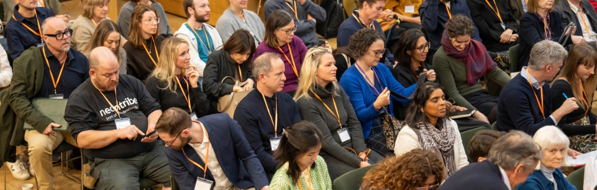 People sat listening to a session at an NPC event