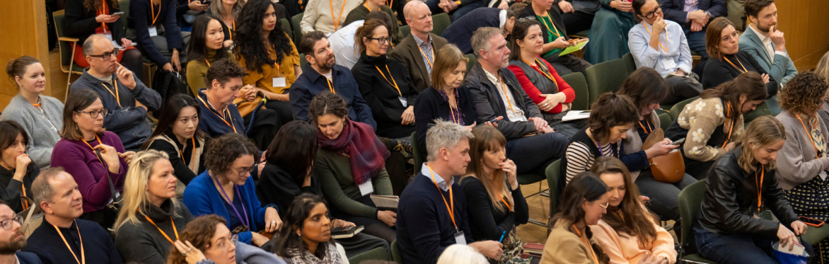 People sat listening to a session at an NPC event