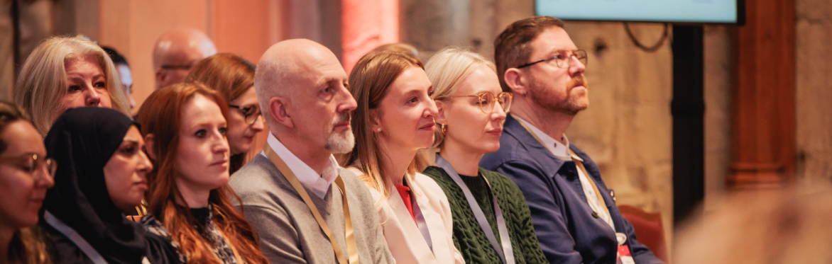 People sat listening to a session at an NPC event