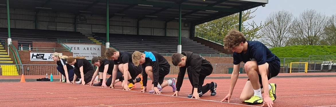 Young athletes in the start position at a track