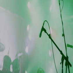 Picture of a microphone on a green background.