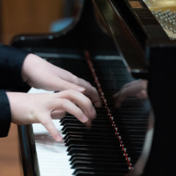 Hands on piano keyboard