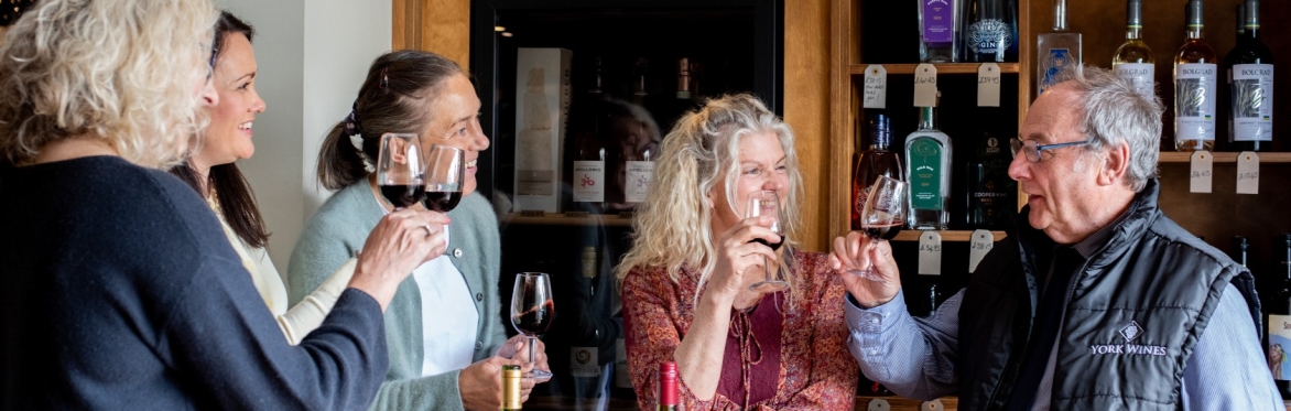 People smiling and drinking wine with each other