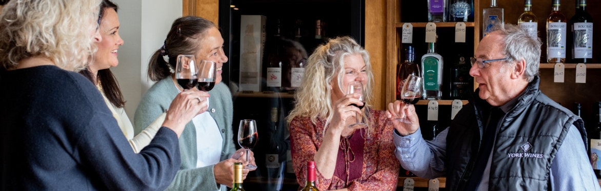 People smiling and drinking wine with each other