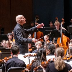 Symphony students stand on stage