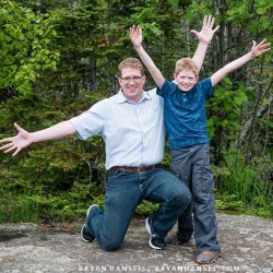 A father and son with arms spread out.