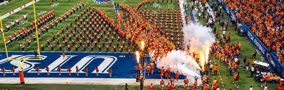Picture of the UTSA football team running onto the field before a game.