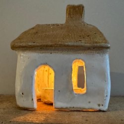Little ceramic tealight house with candle inside