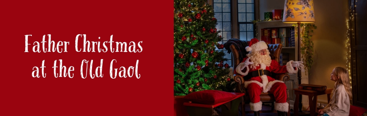 Text reads Father Christmas at the Old Gaol. Father Christmas. is talking animatedly to a young girl with blonde hair who is kneeling on the floor.