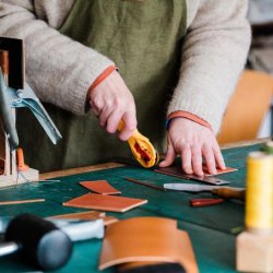 Person cutting leather to make a wallet