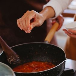 Cooking bowls, ingredients and aprons on a wooden worktop