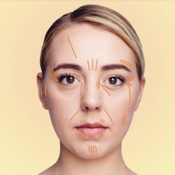 a white woman's face with hair tied back. On the face are lines marking different areas that can indicate signs of illness in Chinese Face reading.