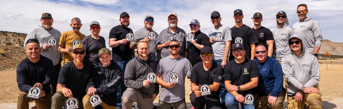 Class Photo - 18 students holding their 1000-yard Milk Jug Challenge Stickers and 4 instructors