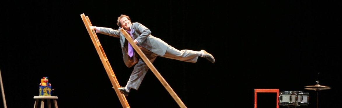 Silly man balances on two ladders.