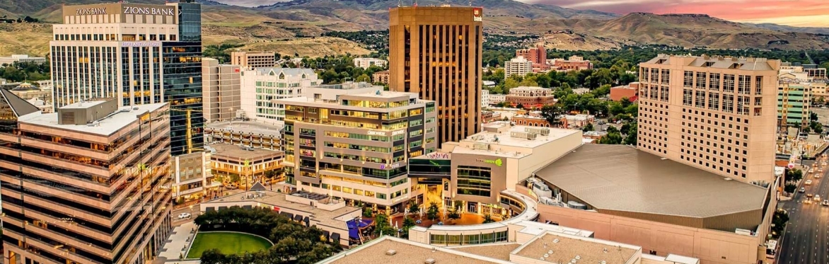 A sunny day with a large mountain range in the background and the Salt Lake cityscape in the foreground