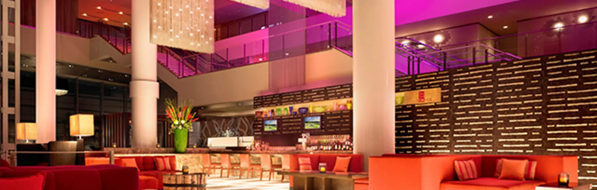 A lobby bar with high ceilings and convivial atmosphere