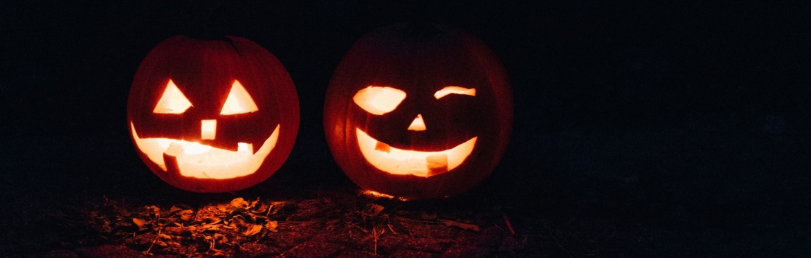 two carved pumpkins lit from inside