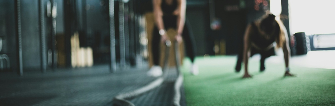Two women in a gym doing pushups