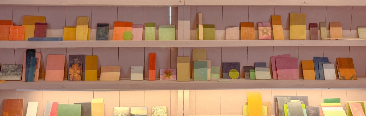 Shelves displaying hundreds of small, coloured blocks and photographs.