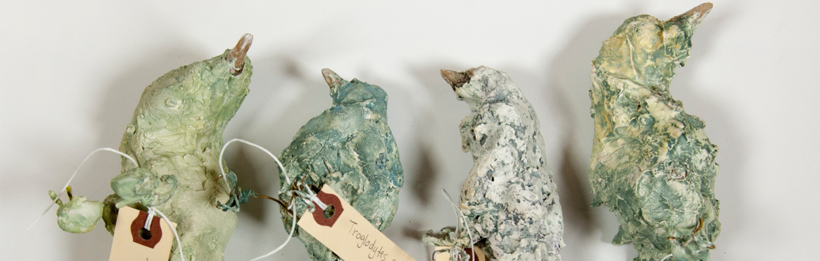 four little sculptures in the shape of birds