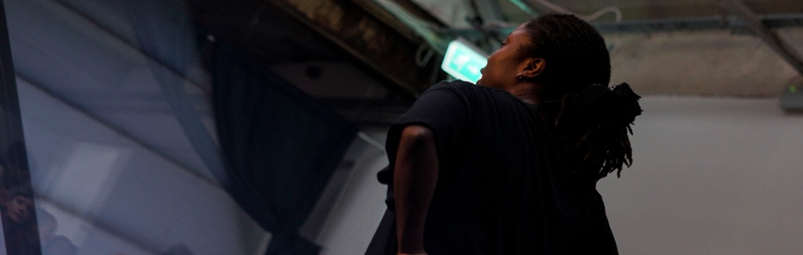 A dancer performs front of an audience