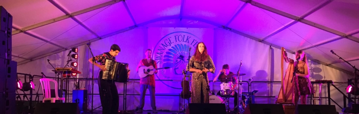 A band on main stage for an evening concert.