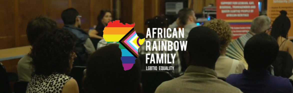 People sitting in a conference room and African Rainbow Family logo