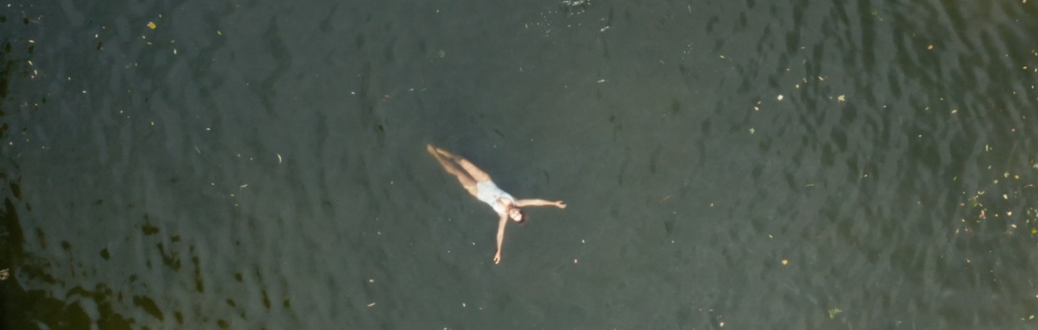 Swimmer floating in the Avon near Bristol.