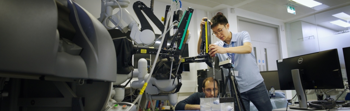 Two Research Technicians working on a robot