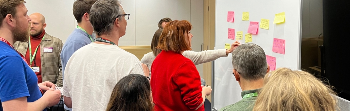 People looking at proposed topics on a whiteboard