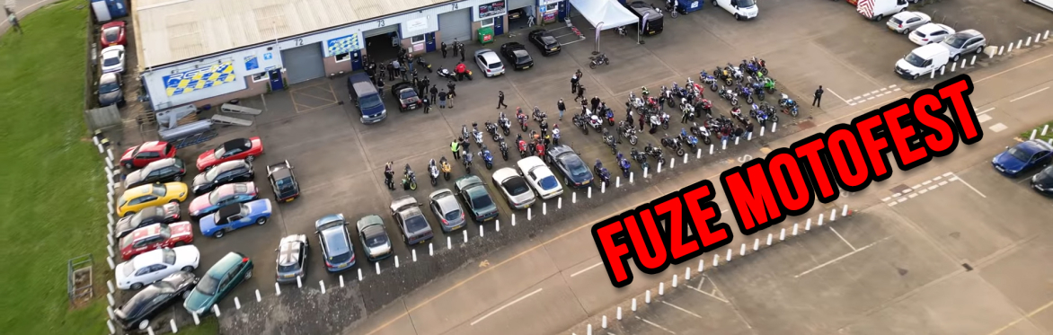 An industrial estate with bikes and cars parked up