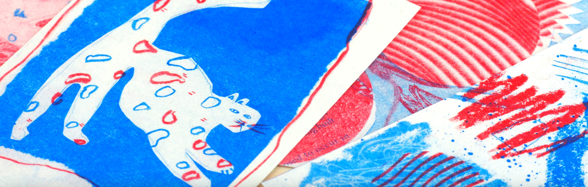 Red and blue rise prints on white paper, one of which is of a cat