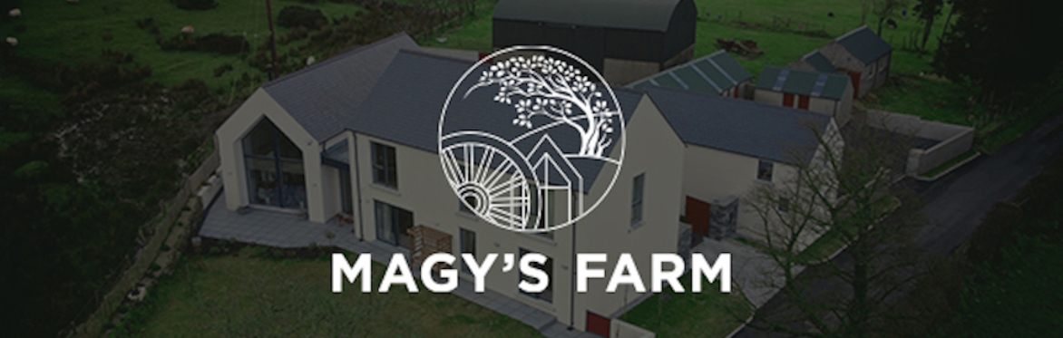 An aerial picture of Magy's Farm with our logo depicting a cartwheel, a sycamore tree and the large window in the kitchen