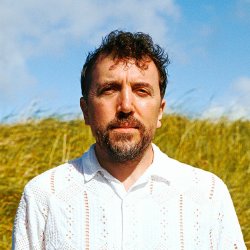 A picture of a man standing in a field
