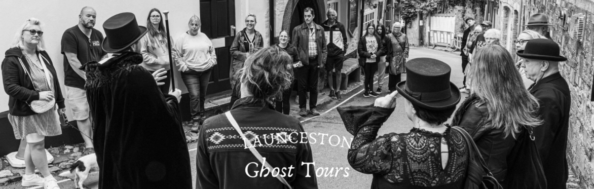 a group gather outside The Bell Inn with a Victorian gentleman