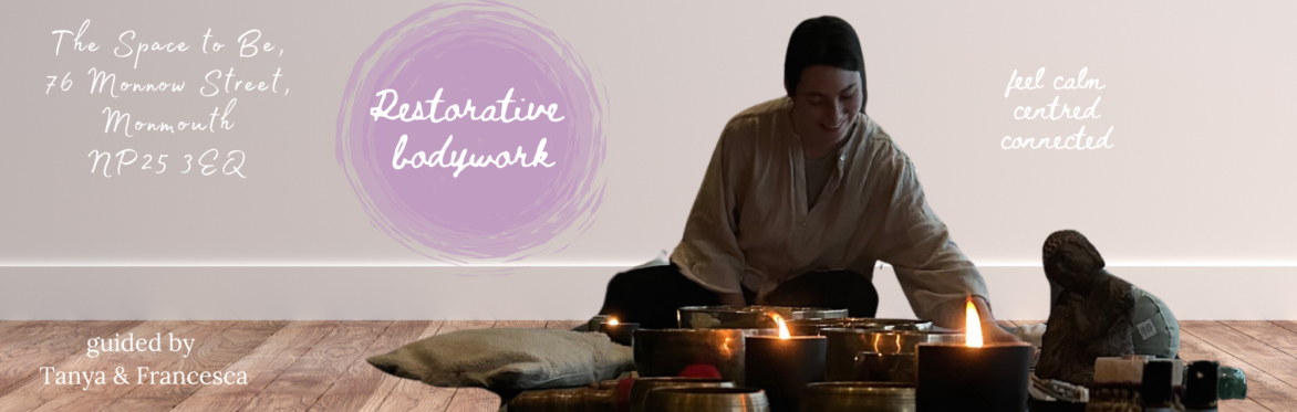 A woman lights a candle in a calm space surrounded by sound bowls and cushions.