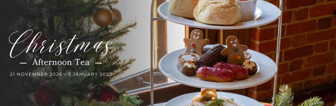 Afternoon tea on a stand with a gingerbread person, mini Christmas pudding, mini yule log, and a Christmas tree. Text says 'Christmas Afternoon Tea'.