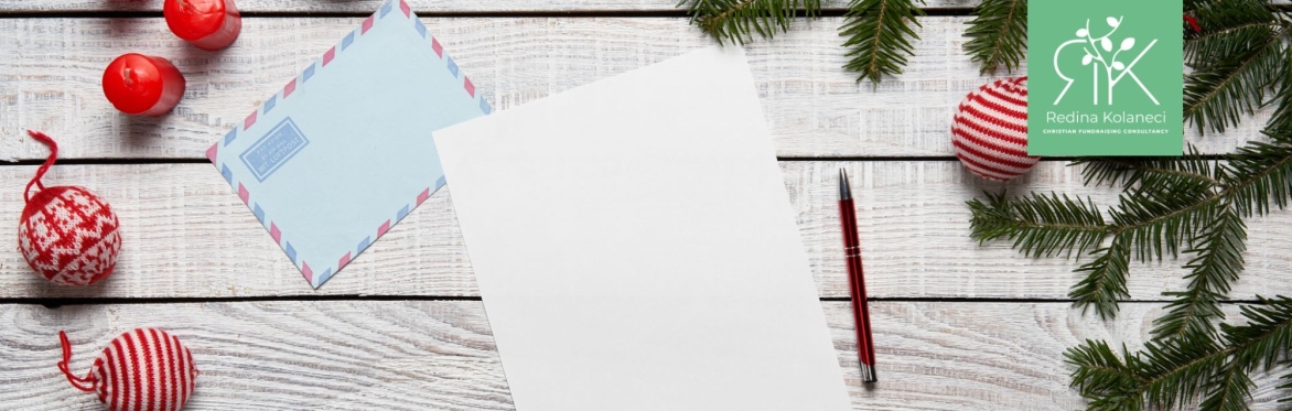 A photo of a table and a piece of paper that represents the christmas appeal, as well as baubles that are christmas decorations