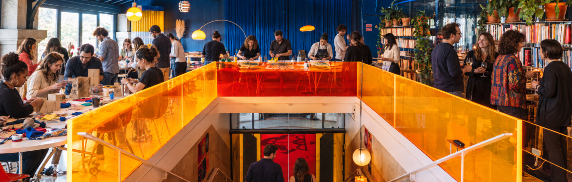 A group of people working creatively in a colourful space a Creative Playground Night.