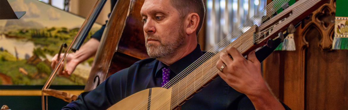 Peter playing theorbo on stage