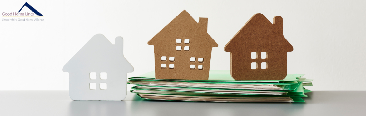 Three homes made of cardboard with the Good Home Lincs logo