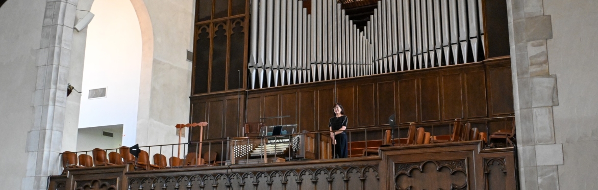 Marianne Kim in front of the organ at Second Presbyterian Church