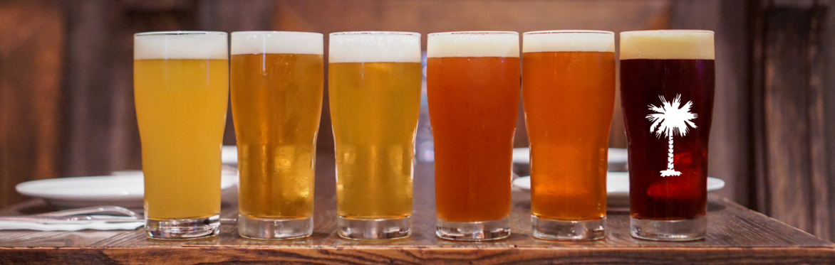 A row of beers sitting on a table.