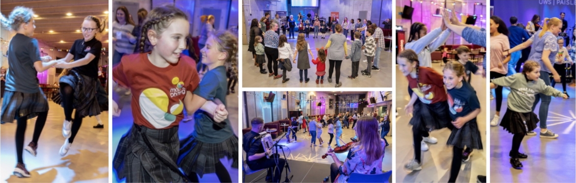 A lively group of adults and children enjoying a ceilidh dance in a bright hall, full of energy and joy.