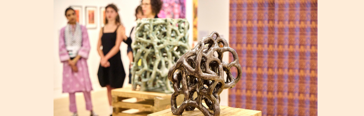 People stood among the artworks in The Stanley & Audrey Burton Gallery